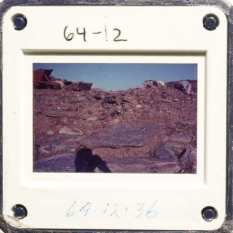 Old photograph with date stamp, showing rocky landscape.