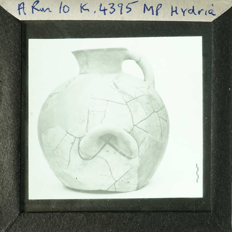 Ancient Greek vase with visible cracks and fissures.