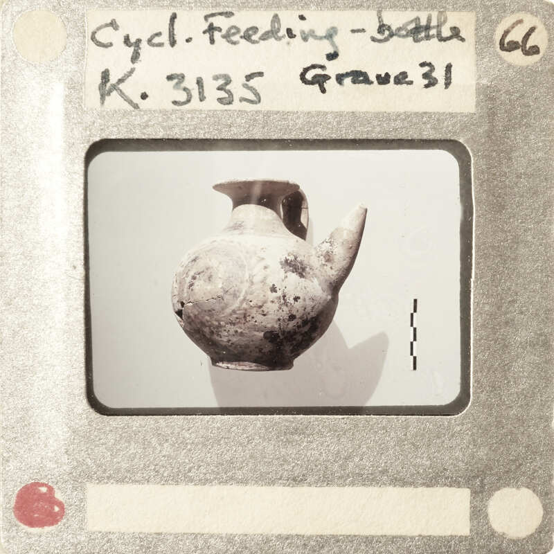 An old, weathered clay vase with a handle and spout.