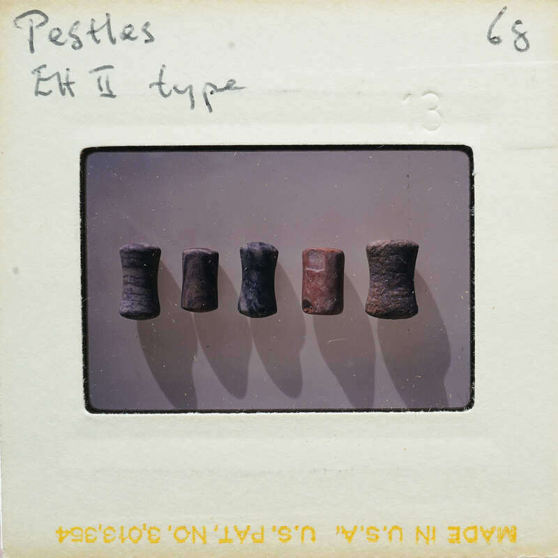 A collection of five cylindrical objects with different colors and textures, displayed on a white surface.