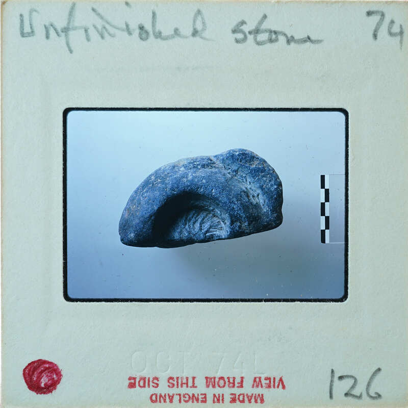 Blue stone fragment with carvings.