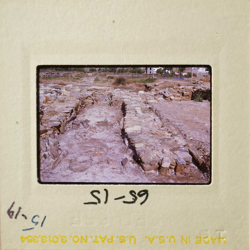 Old ruins with stone columns and walls, possibly part of an ancient city or temple.