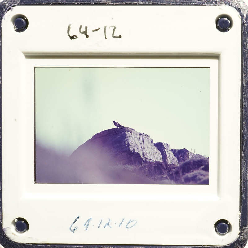 Mountain landscape with rocky terrain and hazy sky.