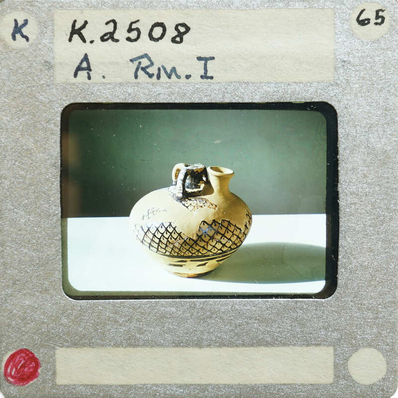 Picture of a stirrup jar (K.2508) on table.