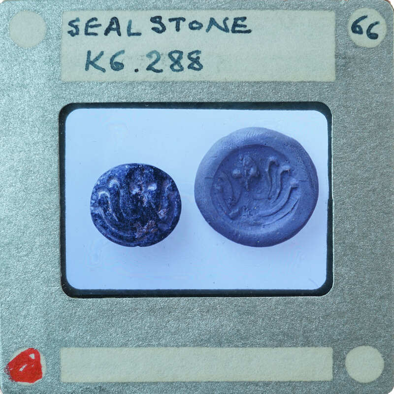Circular stone object on left with carvings K6.288, seal impression on right.