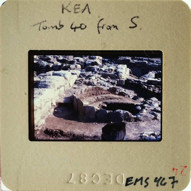 Ancient ruins with stone structures partially excavated from the ground.