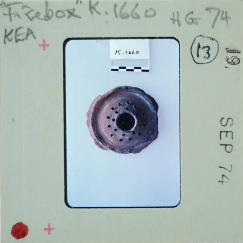 A photograph of a rusted metal object with holes, possibly an antique or historical item, dated September 1974.