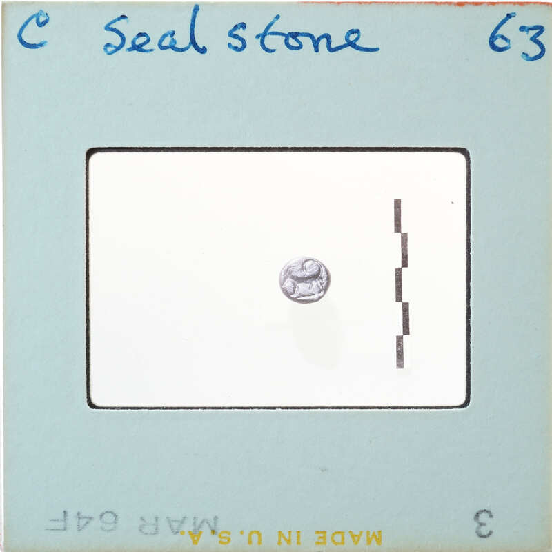 Small circular stone with carvings.