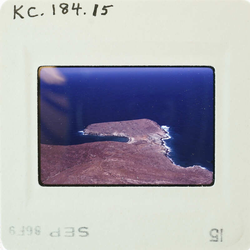 A photograph of a coastline with an island and ocean.