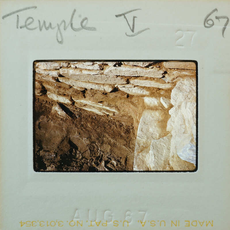 Excavated interior stone wall corner.