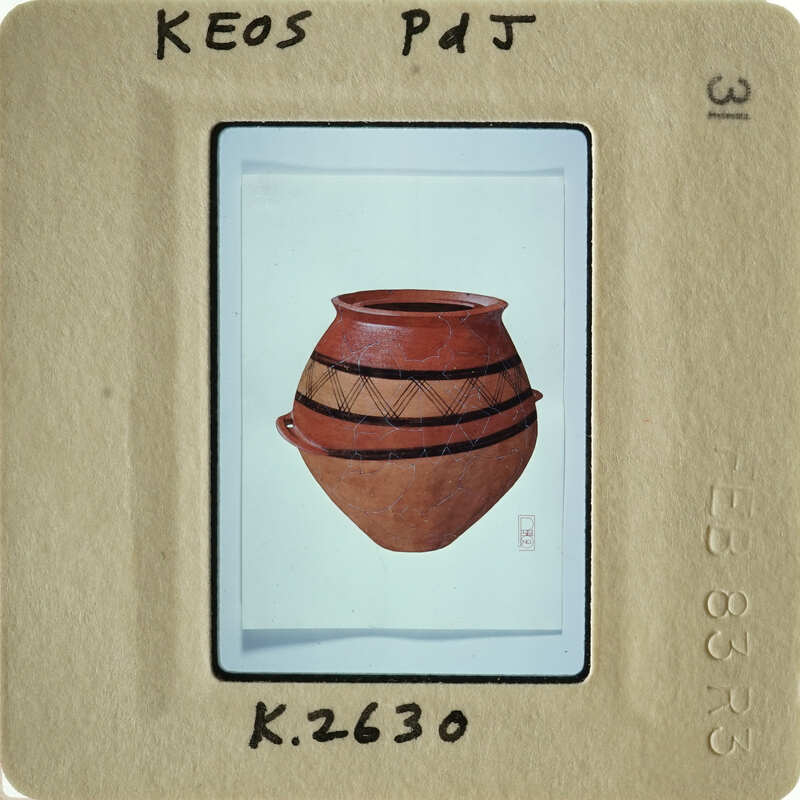 Ancient ceramic pot with intricate design and handle.