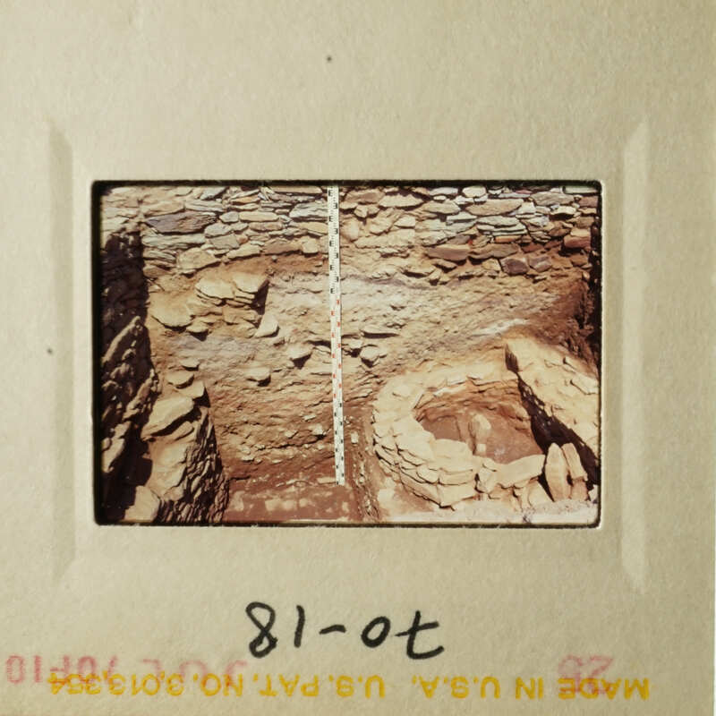 The photo shows an underground cave with a small pit at the bottom.