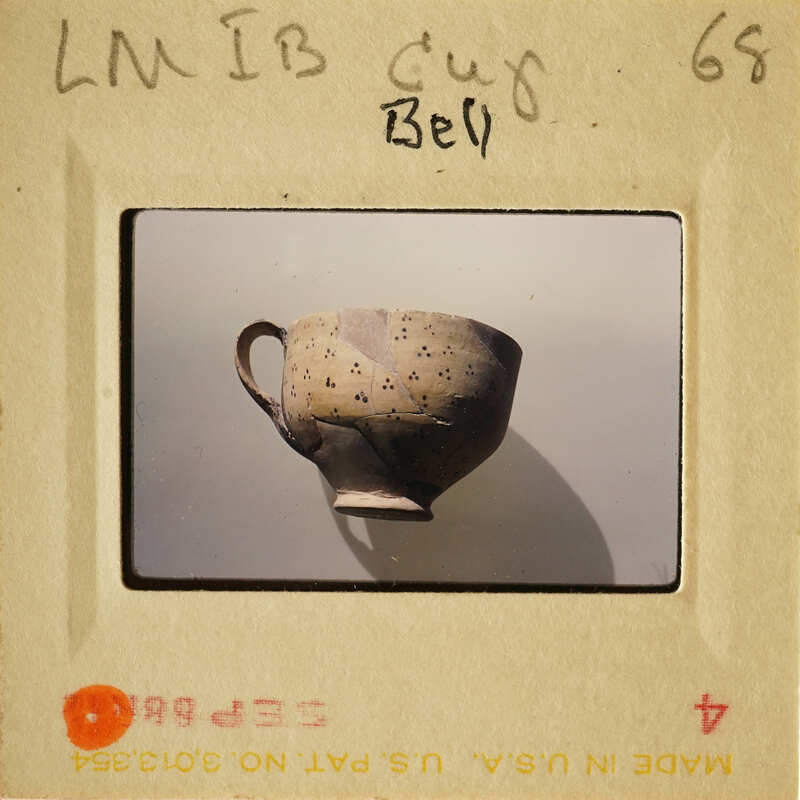 Ancient ceramic cup with handle on display.