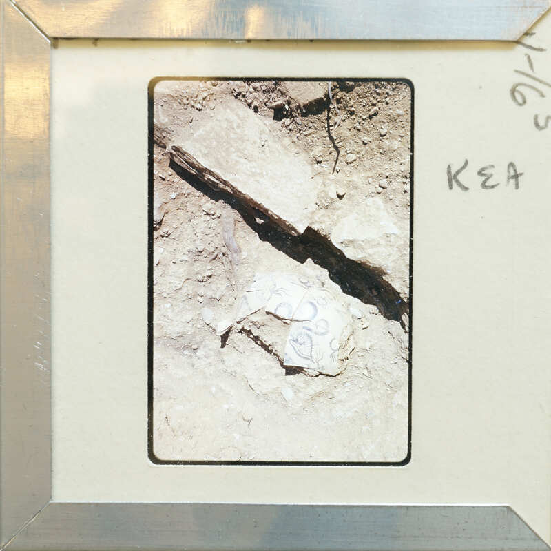 Stone wall with pottery fragments on surface