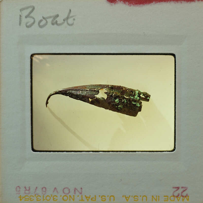 Small metal fragment of what looks to be the hull of a boat.