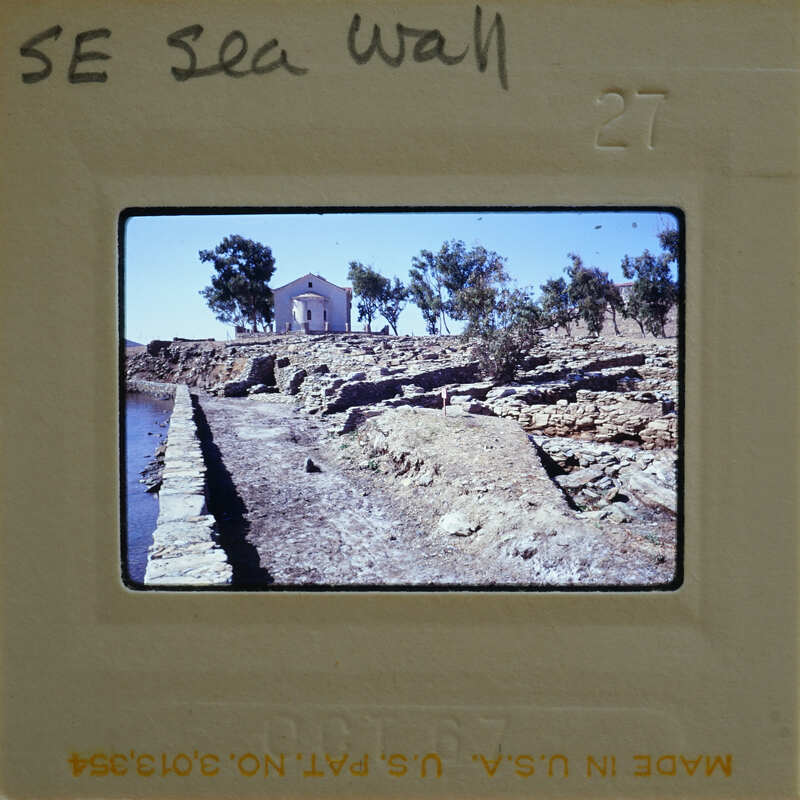 A photograph of a historical site with ruins and a wall, possibly part of an ancient city or fortification.