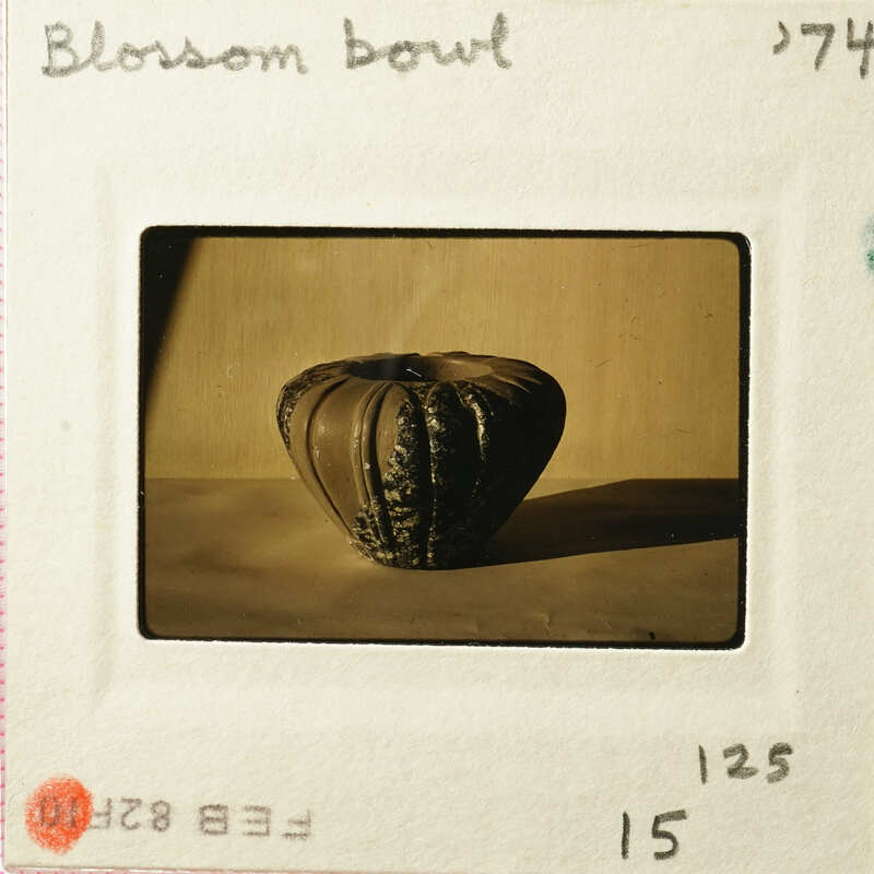 A photograph of an antique vase with intricate designs on display.