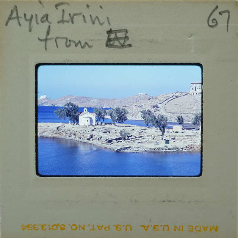 Picture of a scenic coastal landscape with blue water and green trees.