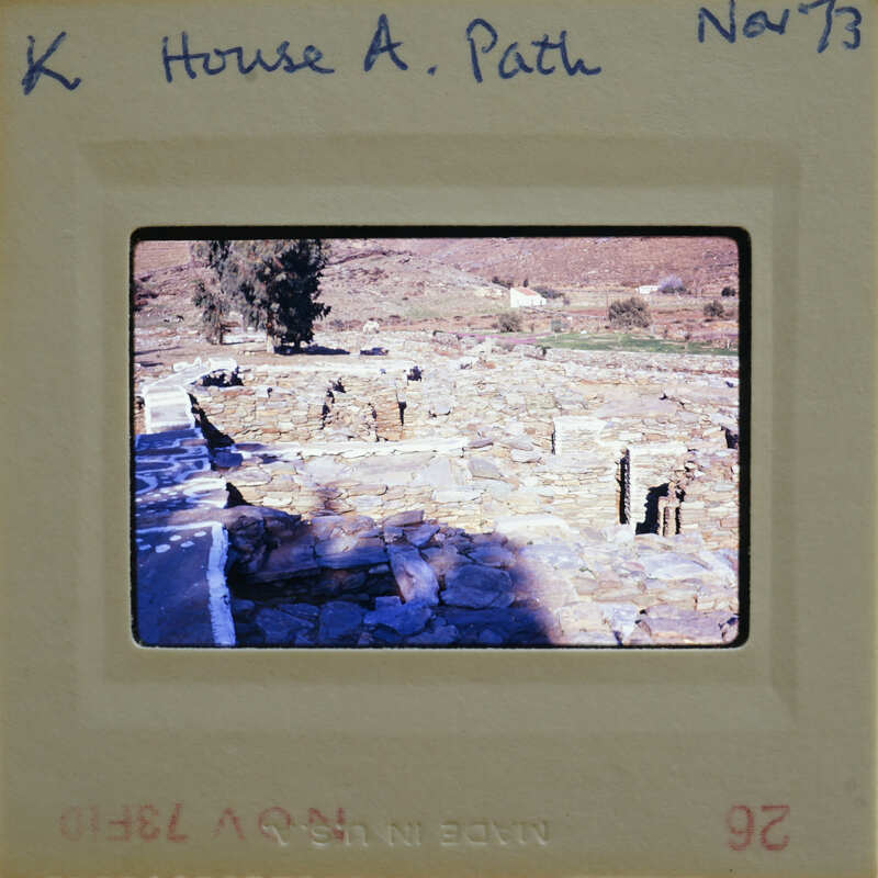 This is a photograph of an ancient stone structure, possibly ruins or a historical site, with trees and shrubs around it.