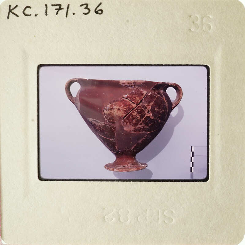 Ancient Greek vase with intricate designs on display.