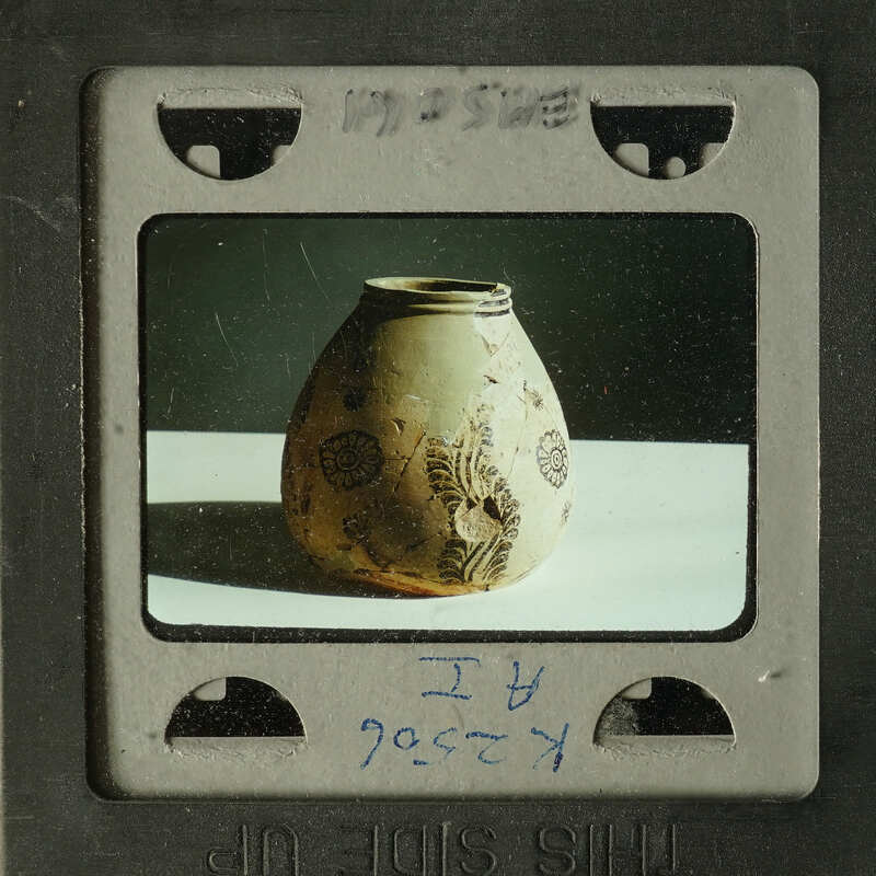 Ancient ceramic vase with intricate designs on display.