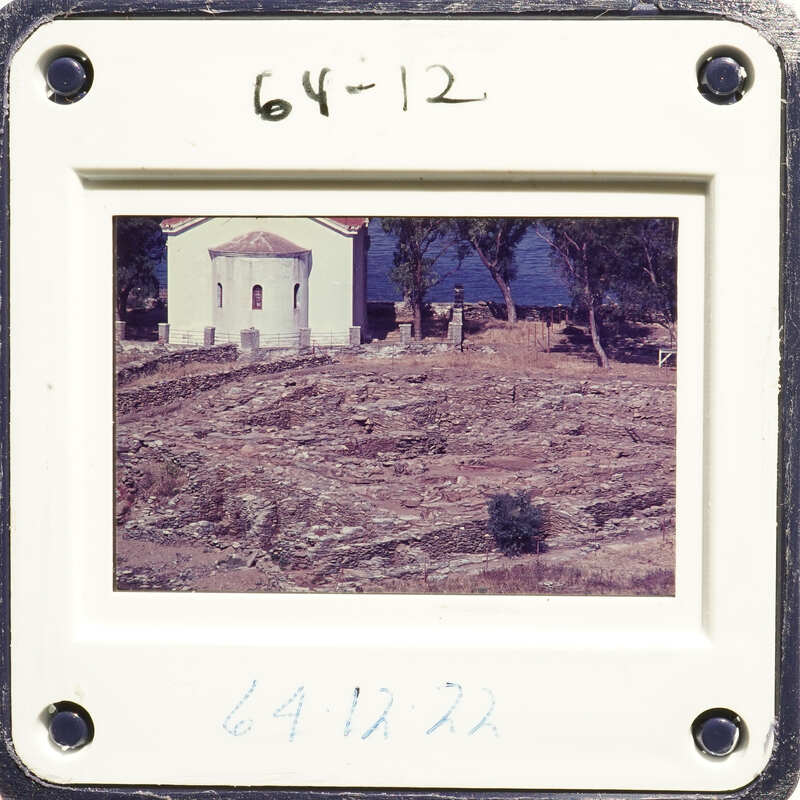 Framed photograph showing an outdoor scene with a building and a field.