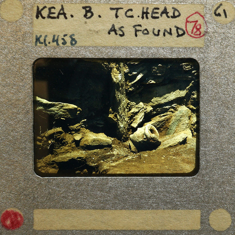 Terracotta figurine head (K1.458) as found on surface of trench next to walls.