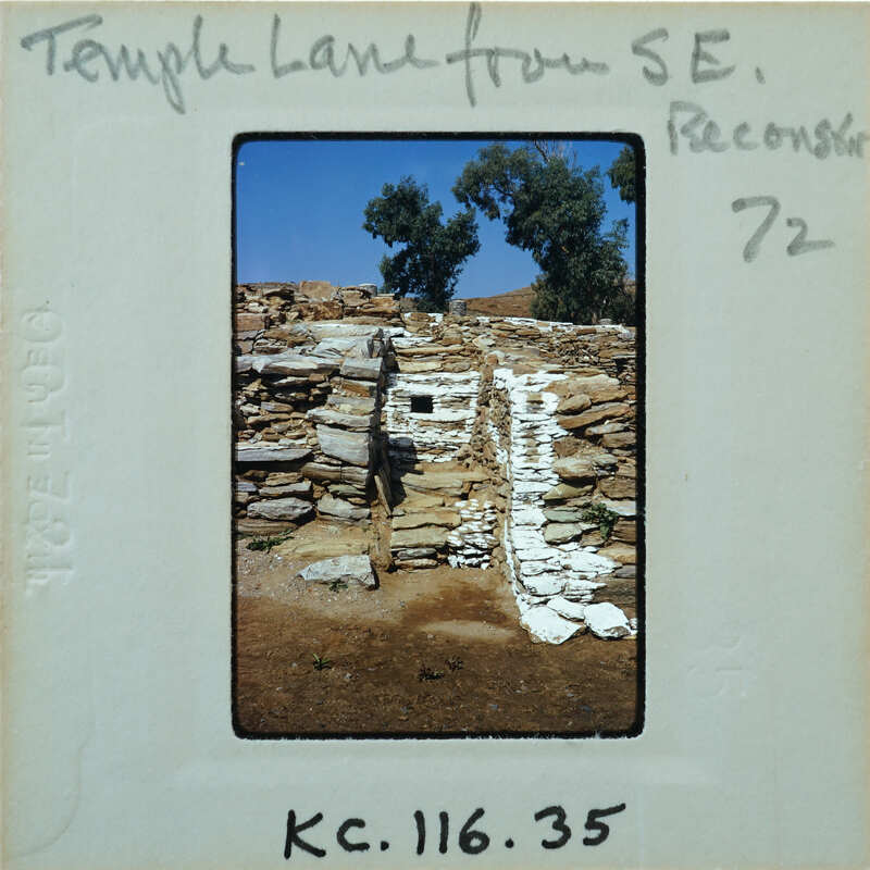 Old stone ruins with a dirt path and trees.