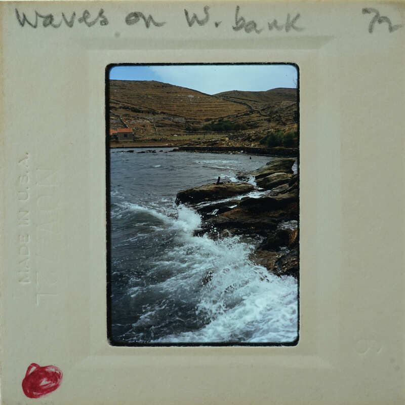 Photo of a rocky coastline with waves crashing against the shore.