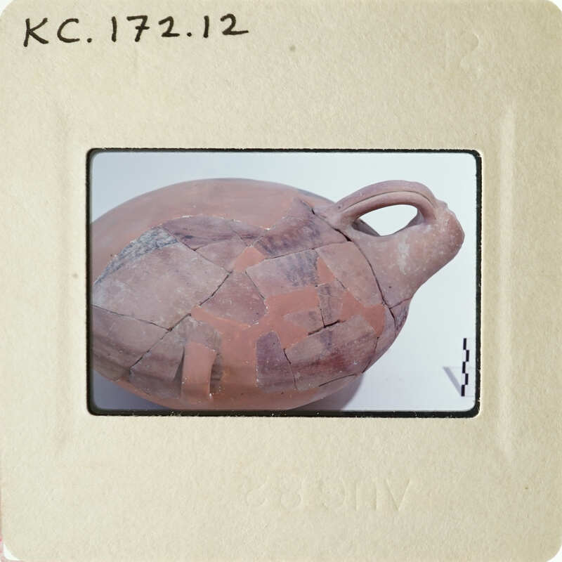 Ancient clay pot with visible cracks and imperfections.