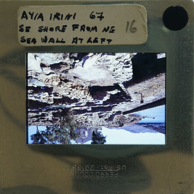 Upside-down photograph of a rocky coastline on a film strip with handwritten notes.