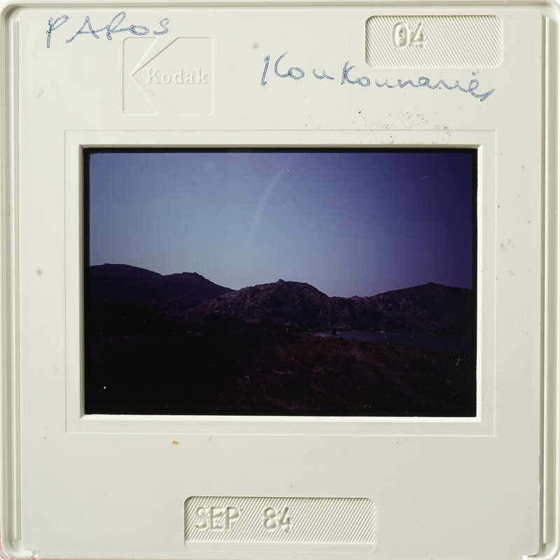 Mounted photograph of mountains and water with handwritten notes on border.