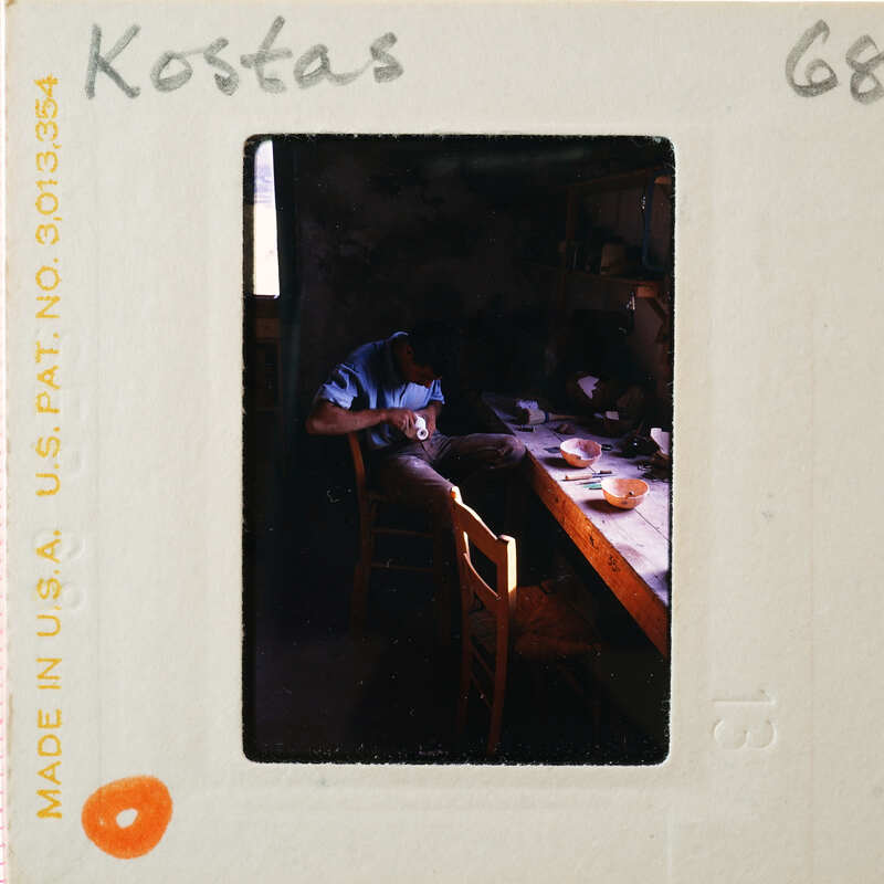 A vintage photograph of a man working at a pottery wheel with an old-fashioned camera film strip border.