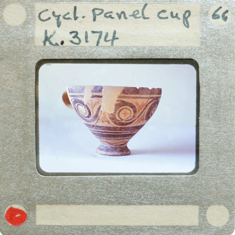 A panel cup (K.3174) with a handle and intricate patterns on display.