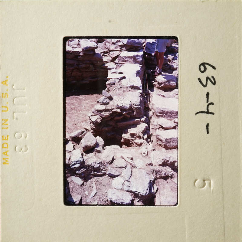 This is an old photograph of a stone structure, possibly ruins, with visible damage and erosion.