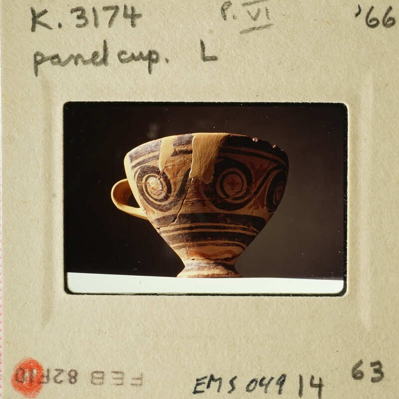 Ancient Greek style ceramic cup with intricate designs.