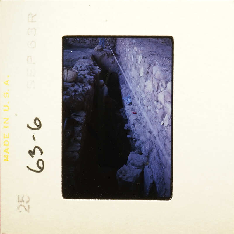 Old photograph showing an underground tunnel with stone walls and debris.