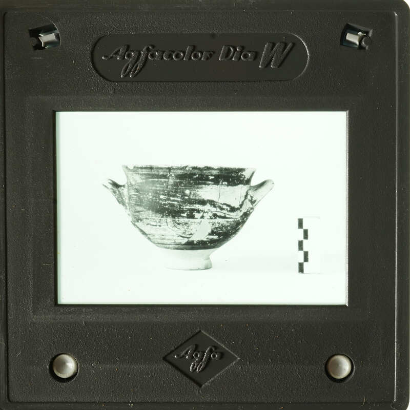 A photograph of an antique bowl displayed on a slide viewer.
