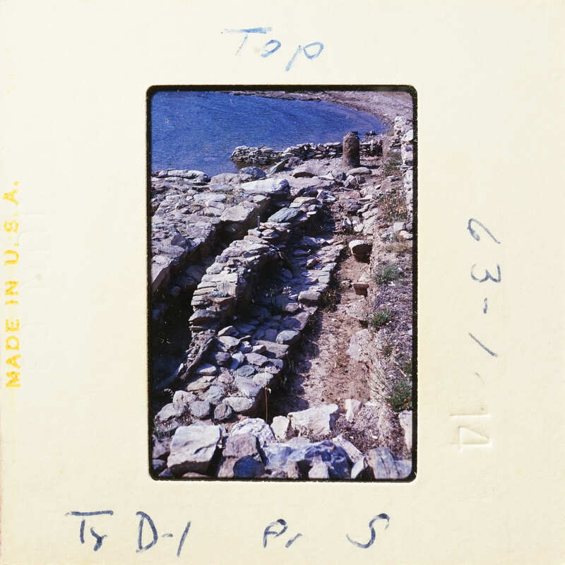 A photograph showing an ancient stone wall along a rocky coastline.