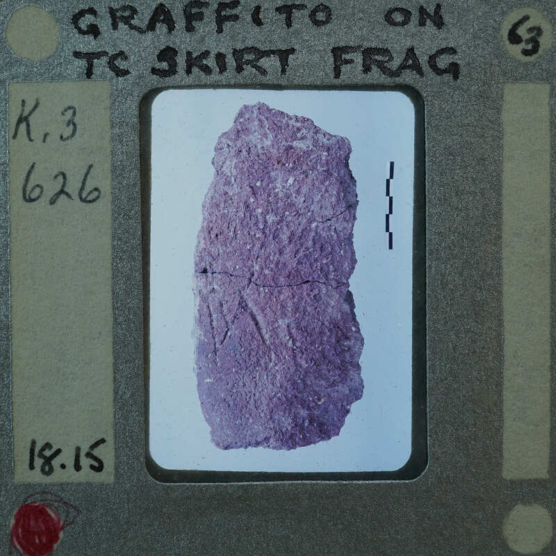 A photograph of a purple rock with cracks on a film strip.