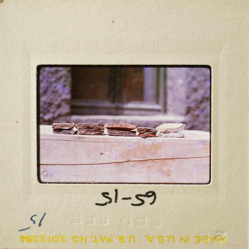 Broken pottery sherds on display with visible signs of age and use.