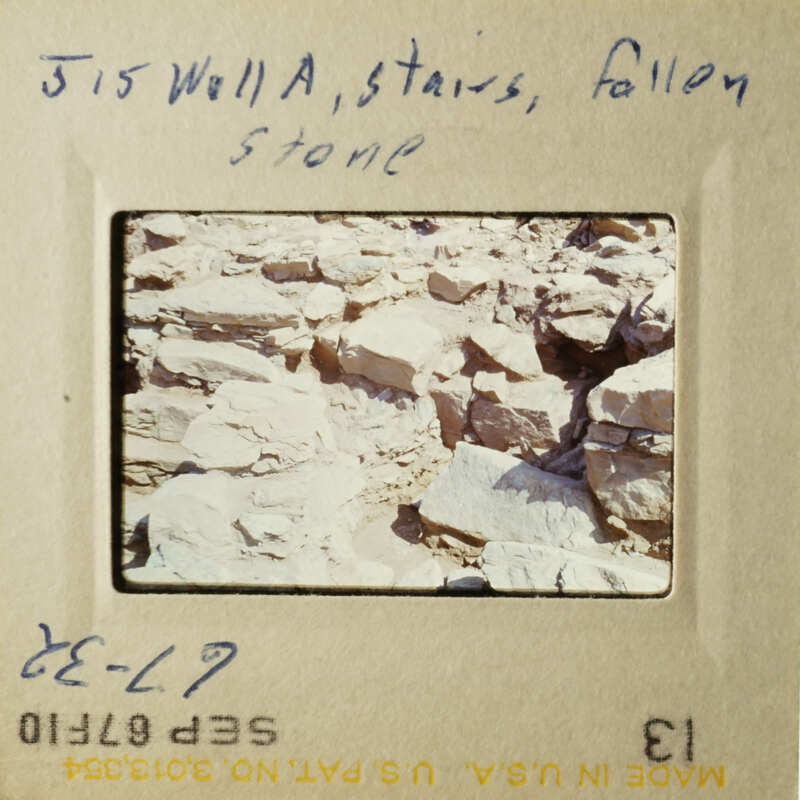 This is an old photograph of a rocky landscape with a handwritten note.