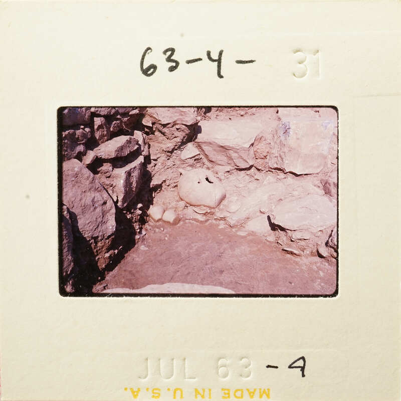 Ancient ruins with exposed rocks and stones, possibly part of an archaeological site.