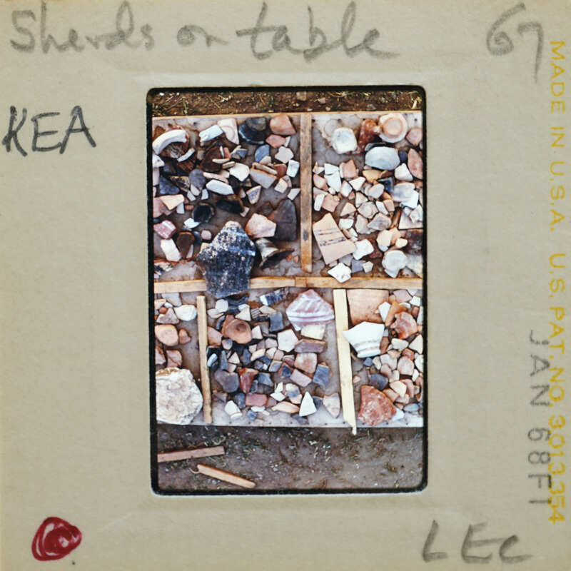 A slide of a table covered with various pottery sherds.
