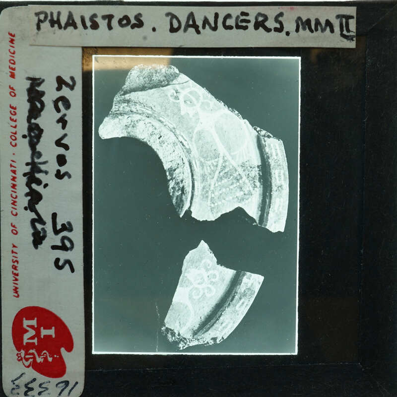 Old ceramic shards with intricate designs, displayed on a card.