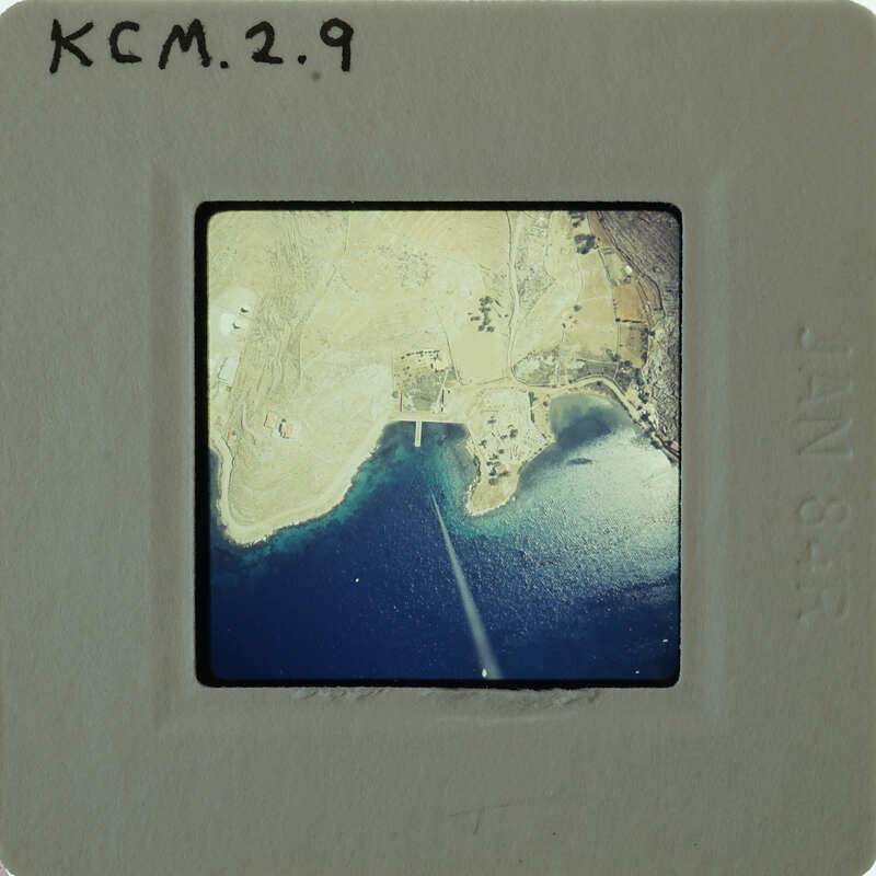 Aerial photo of a coastline on a small film strip.