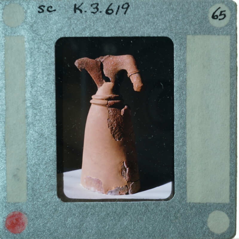 Headless terracotta statue from the front.