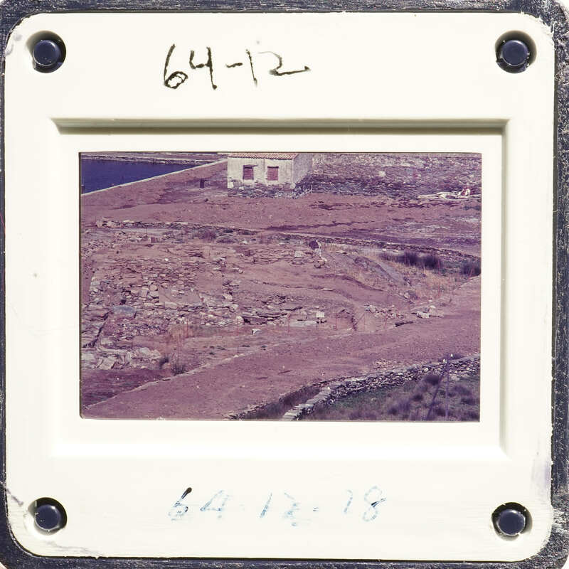 Aerial photo of an island with sparse vegetation and a body of water.