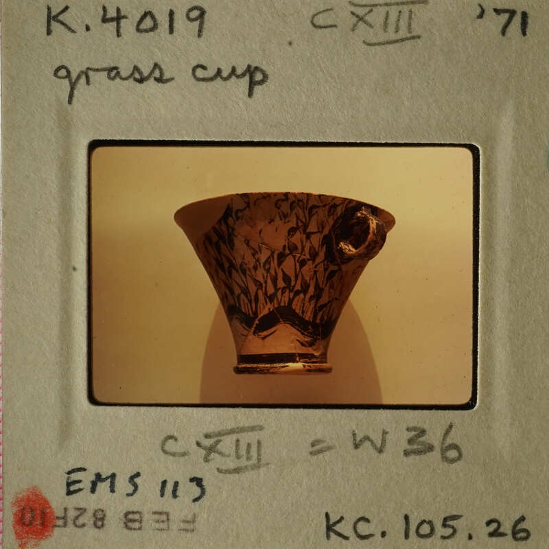 An antique cup with intricate designs on display.