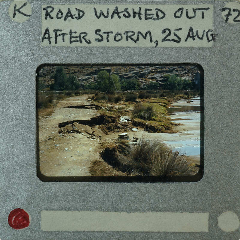 A photograph of a washed-out road with damage from flooding, taken on August 25th.